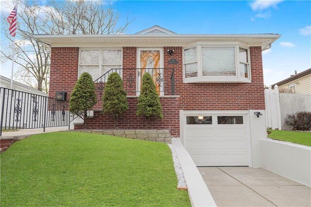 view of front of house with a front yard and a garage