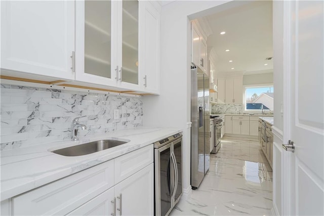 kitchen with decorative backsplash, light stone countertops, and white cabinetry