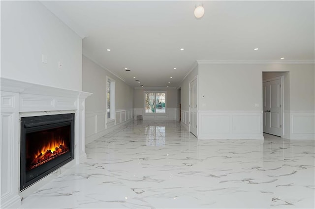 unfurnished living room with ornamental molding and a fireplace