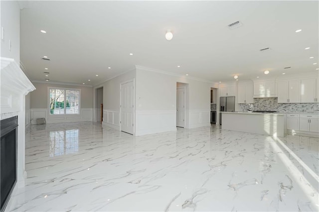 unfurnished living room featuring ornamental molding