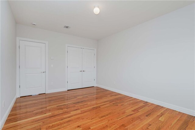 unfurnished bedroom featuring light wood-type flooring