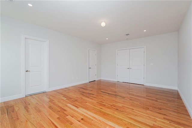 empty room with light hardwood / wood-style flooring