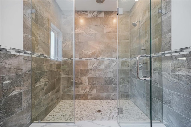 bathroom featuring a shower with shower door