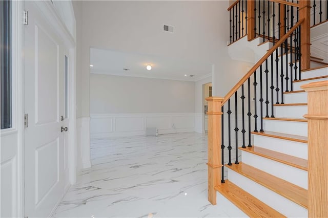 stairs featuring crown molding