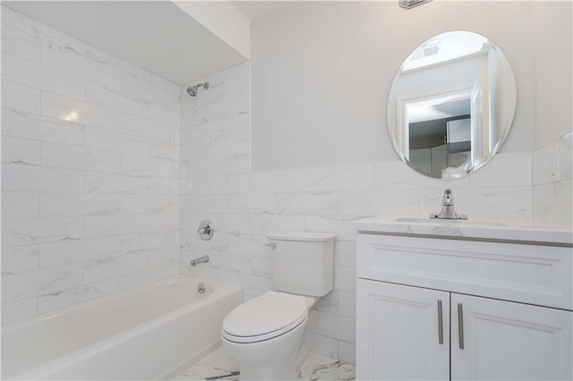 full bathroom featuring tile walls, tiled shower / bath combo, vanity, and toilet