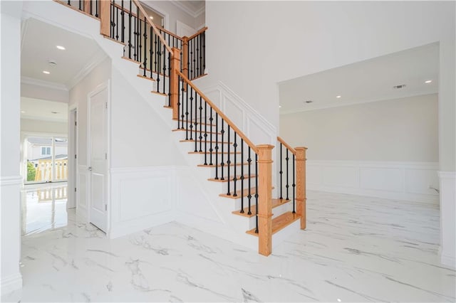 staircase featuring crown molding