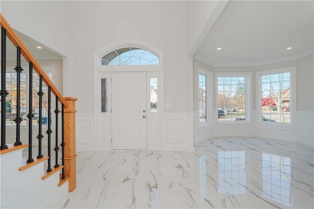 entrance foyer featuring ornamental molding