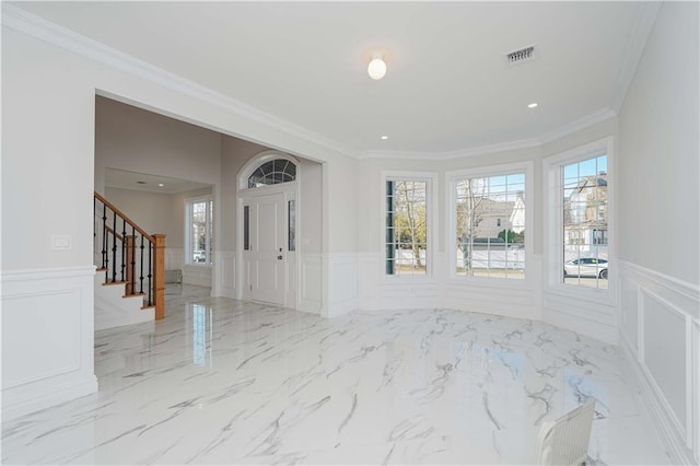 foyer featuring ornamental molding