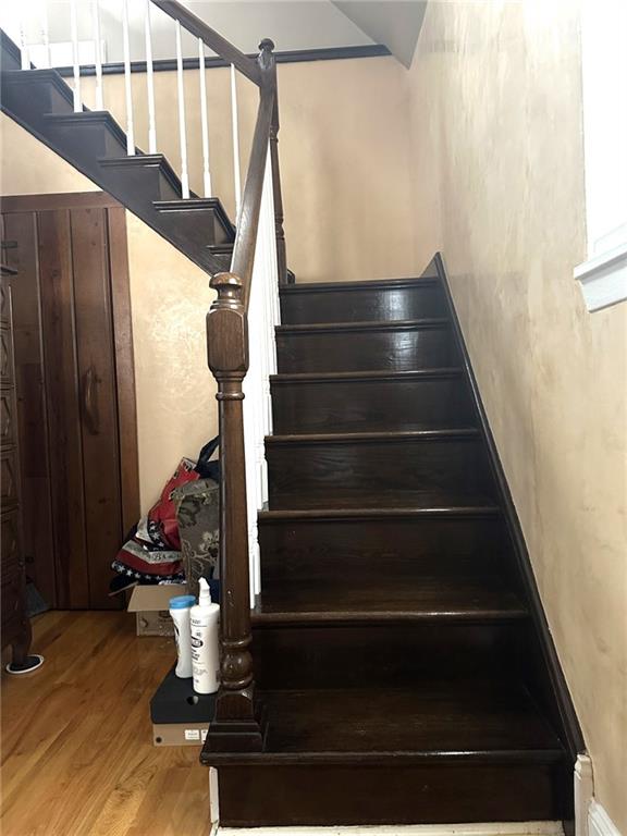 stairs featuring wood-type flooring