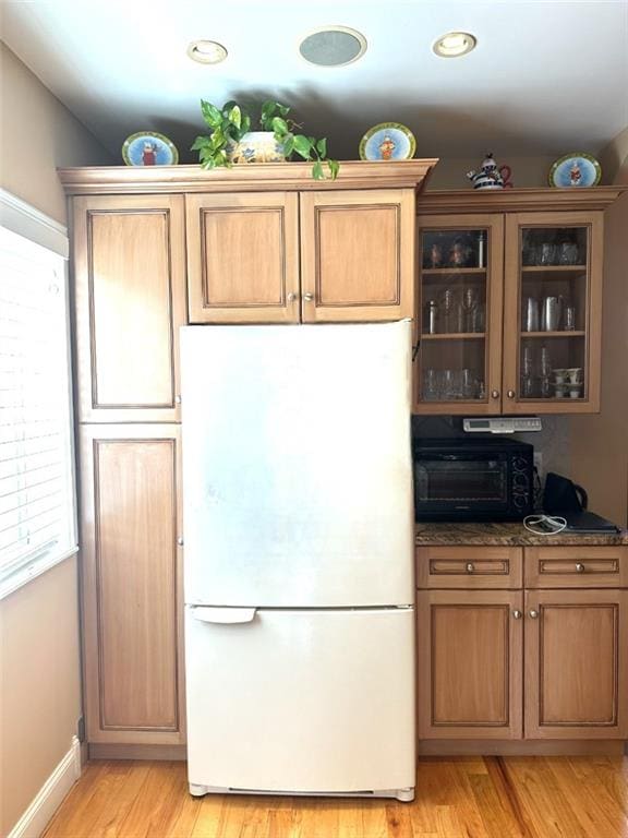 kitchen with light hardwood / wood-style flooring and white fridge