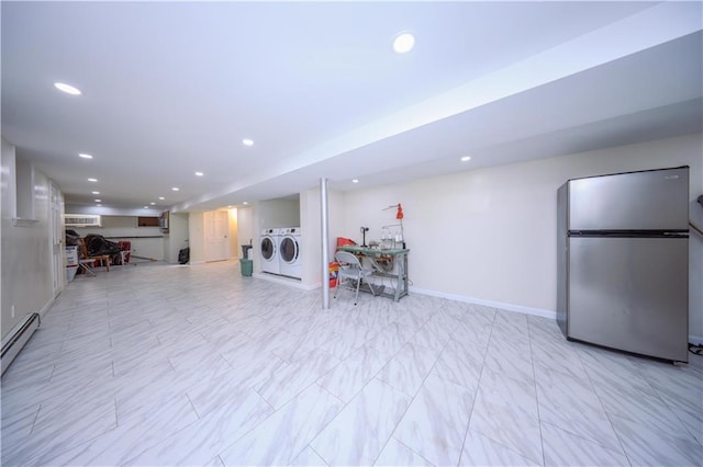 basement with separate washer and dryer, stainless steel refrigerator, baseboard heating, and an AC wall unit