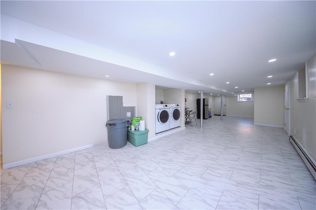 clothes washing area with washer and dryer, baseboard heating, and water heater