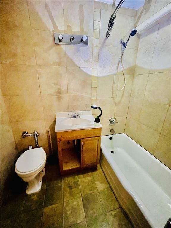 full bath with toilet, washtub / shower combination, tile walls, and vanity