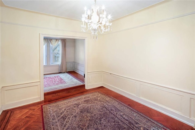 interior space featuring parquet floors and an inviting chandelier