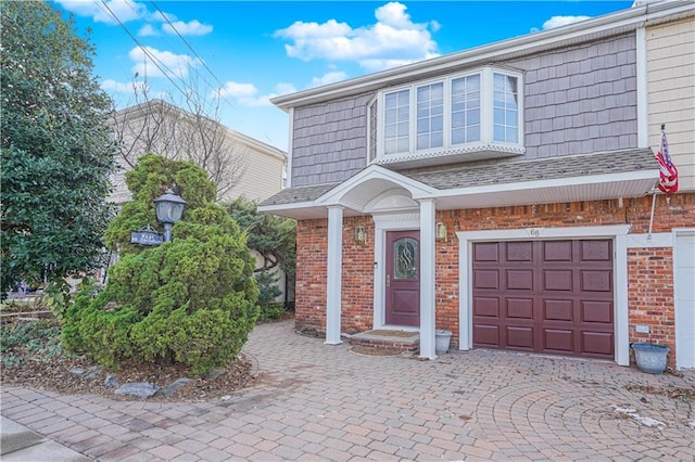 doorway to property with a garage