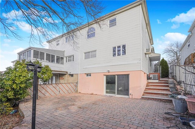 back of house featuring a patio area and a sunroom