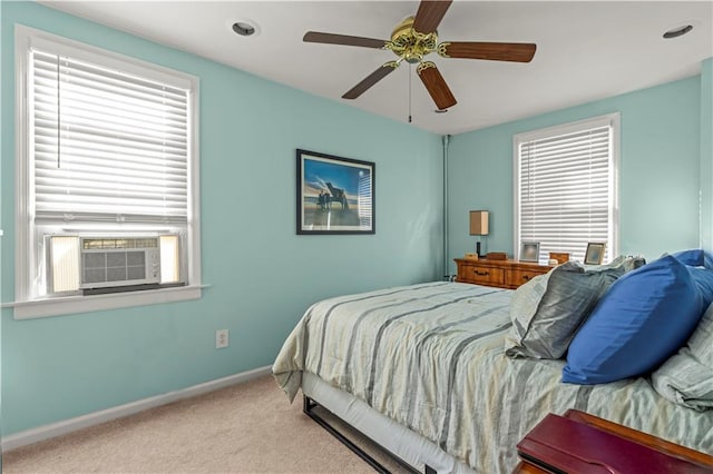 bedroom with ceiling fan, light carpet, and cooling unit