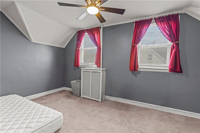 bedroom featuring ceiling fan, light carpet, and vaulted ceiling