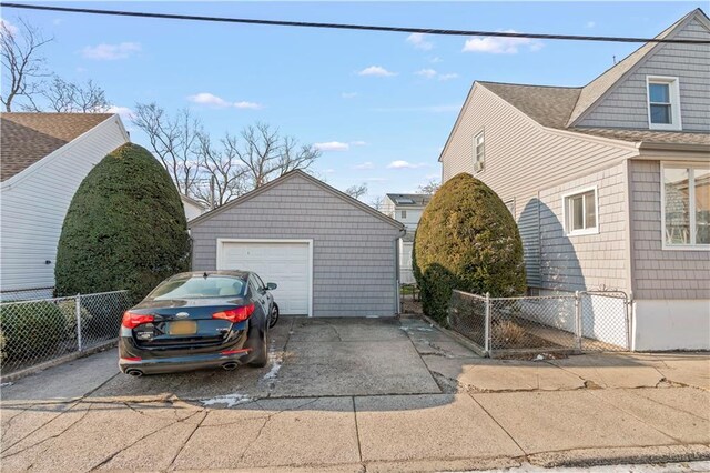 view of property exterior featuring a garage and an outbuilding