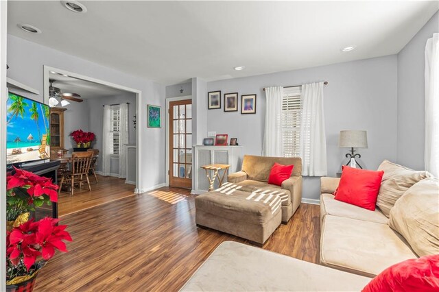 living room with ceiling fan and hardwood / wood-style flooring