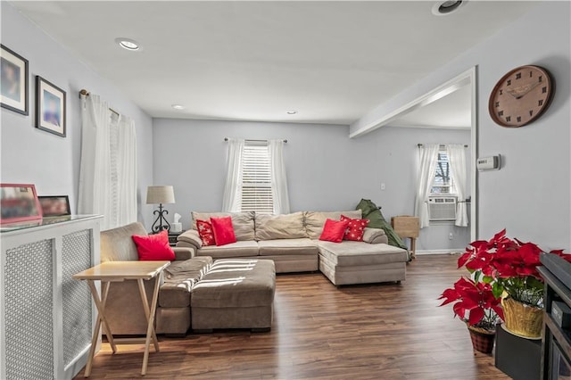 living room featuring dark wood-type flooring, a wealth of natural light, and cooling unit