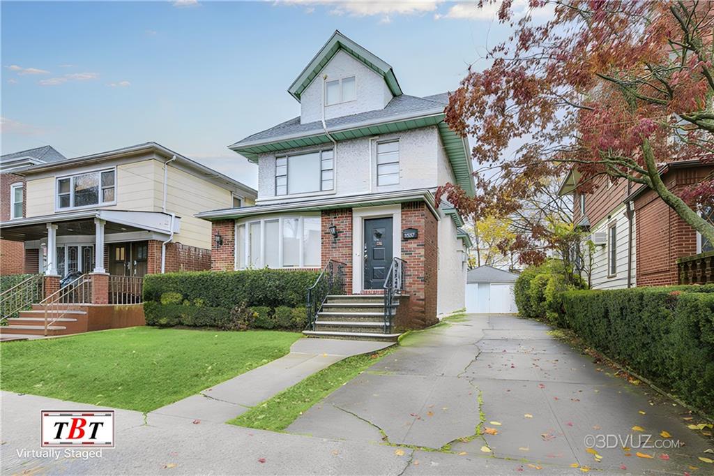 traditional style home featuring an outbuilding, a front yard, a detached garage, and brick siding