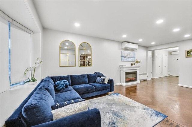 living room with dark parquet floors, radiator heating unit, and a wall mounted AC