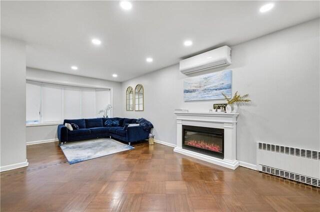 living room featuring a wall mounted AC, parquet flooring, and radiator heating unit