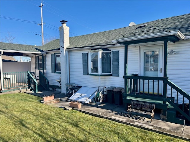 back of property with a lawn and a patio