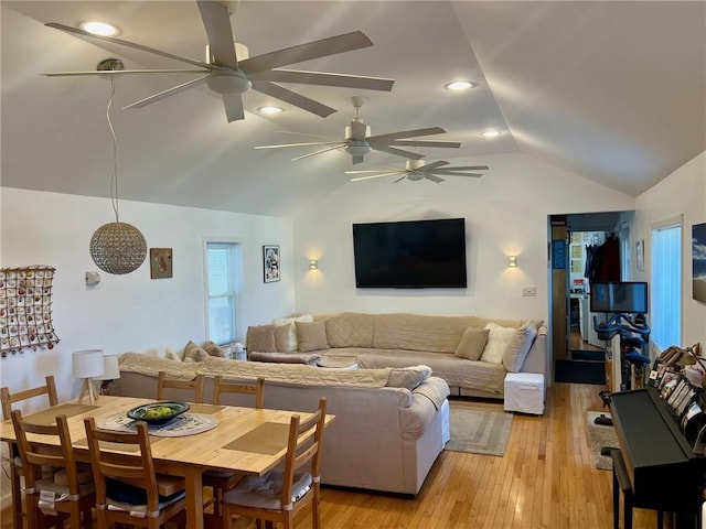 living room featuring ceiling fan, lofted ceiling, and light hardwood / wood-style floors