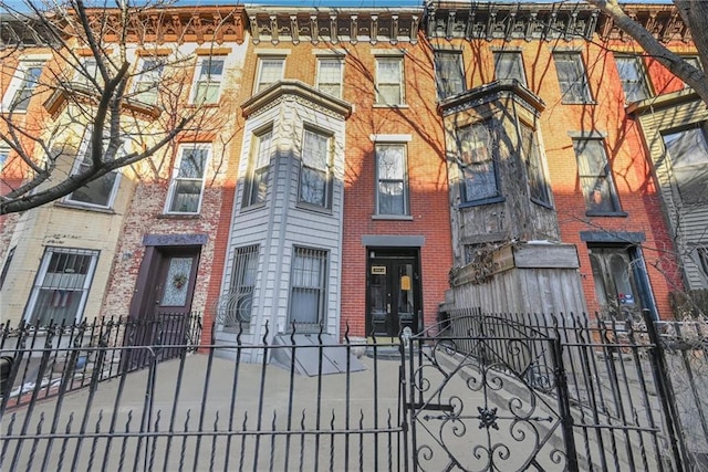 view of front of house featuring a fenced front yard and brick siding