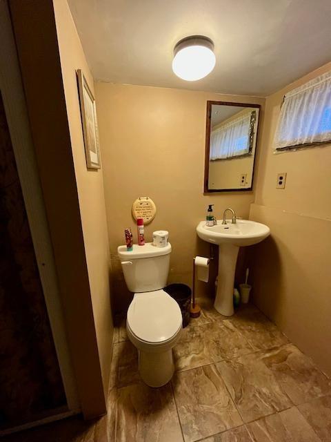 half bath with toilet and a sink