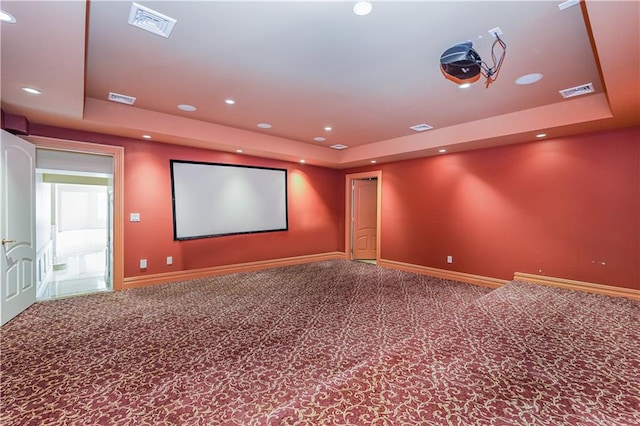 cinema with a raised ceiling, baseboards, visible vents, and carpet floors