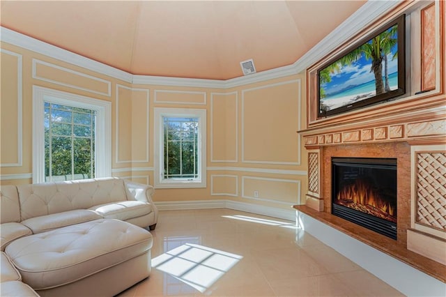tiled living room featuring visible vents, a decorative wall, and a fireplace