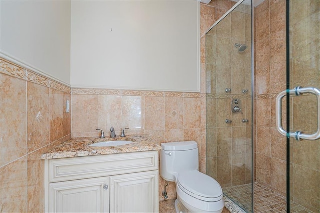 bathroom with tile walls, a stall shower, and toilet