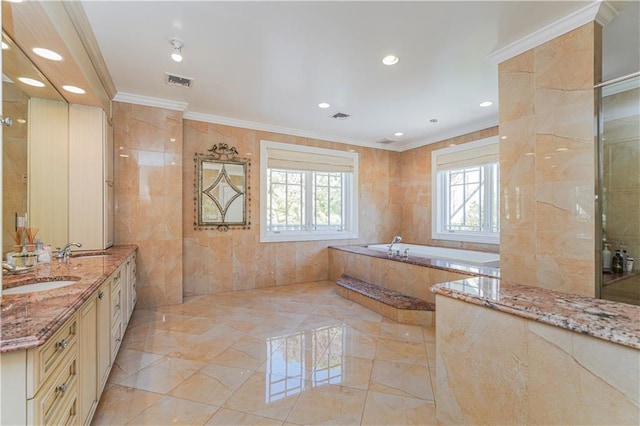 bathroom featuring vanity, a relaxing tiled tub, tile walls, and ornamental molding