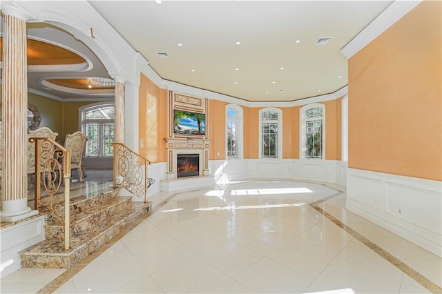 interior space featuring tile patterned floors, ornate columns, and ornamental molding