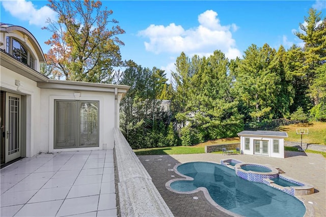 view of swimming pool with an outbuilding, a patio, french doors, and a pool with connected hot tub