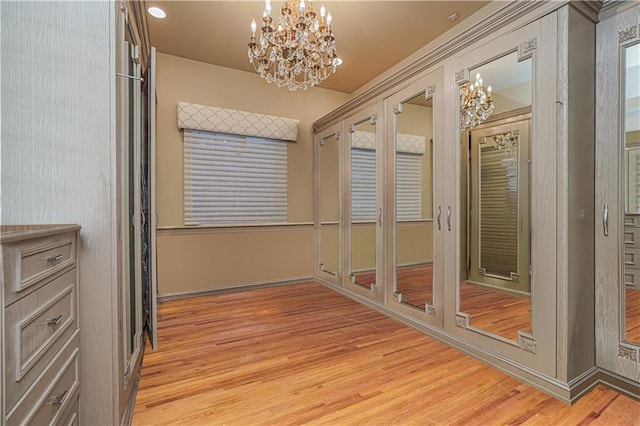 interior space featuring an inviting chandelier and light hardwood / wood-style floors