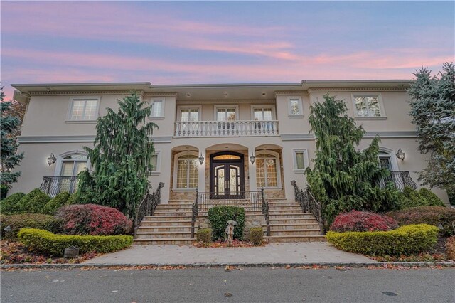 view of front of home with a balcony and covered porch