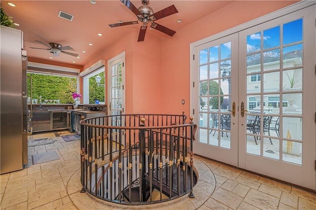 interior space featuring recessed lighting, stone tile floors, visible vents, a ceiling fan, and wine cooler