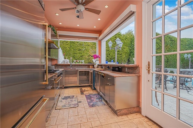 kitchen featuring ceiling fan, beverage cooler, and premium appliances