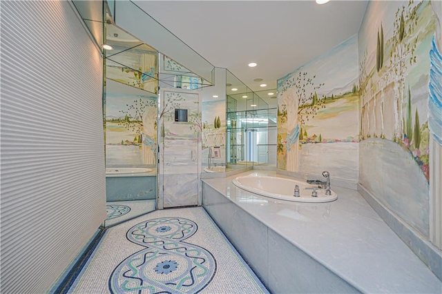 bathroom with vanity and tiled bath