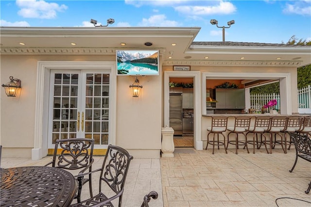 view of patio with french doors and exterior bar