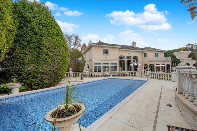 view of swimming pool featuring a patio area