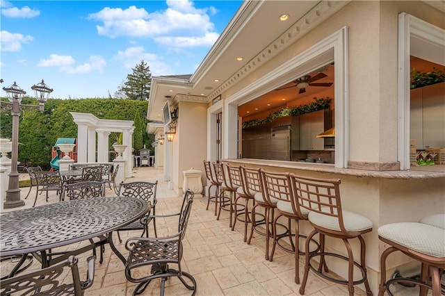 view of patio / terrace featuring outdoor dry bar