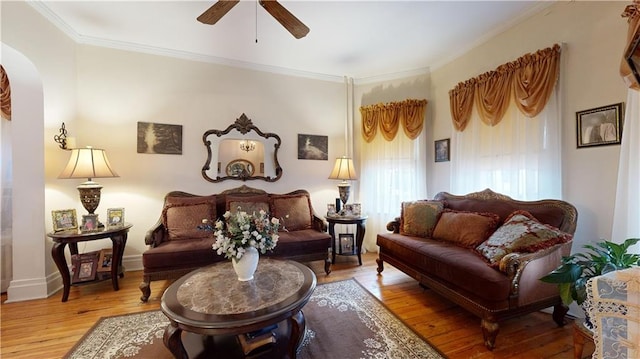 sitting room with hardwood / wood-style flooring, ornamental molding, and ceiling fan