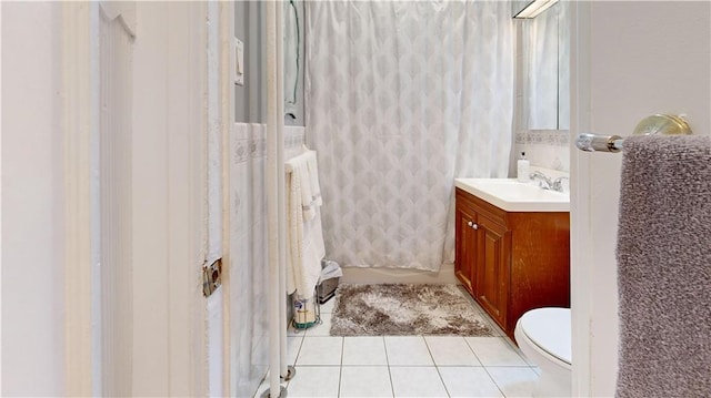 bathroom with vanity, tile patterned floors, and toilet