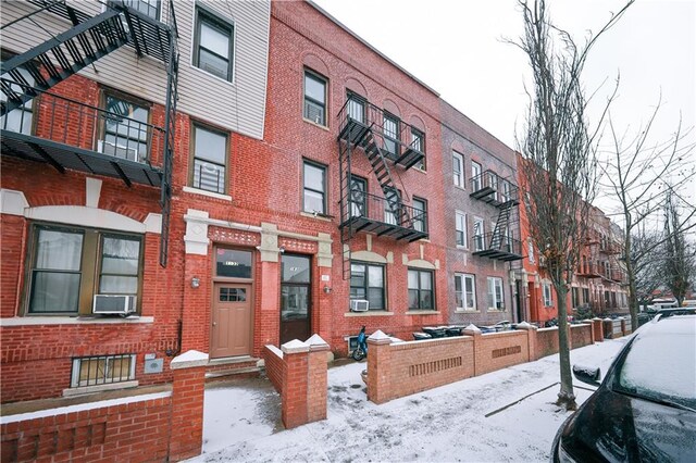 snow covered property featuring cooling unit