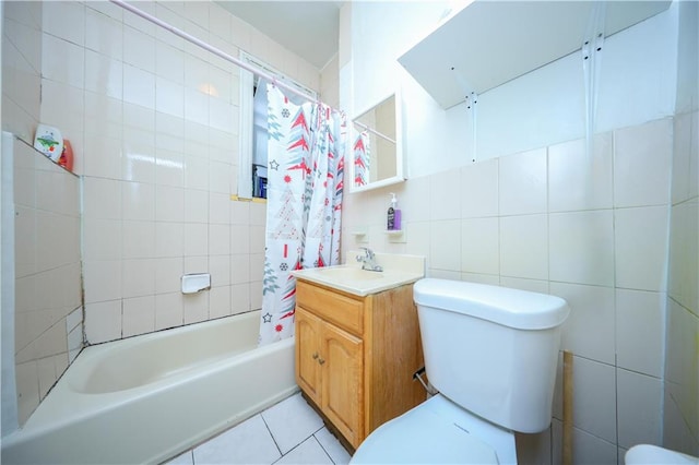 full bathroom featuring toilet, vanity, tile walls, tile patterned floors, and shower / bath combo